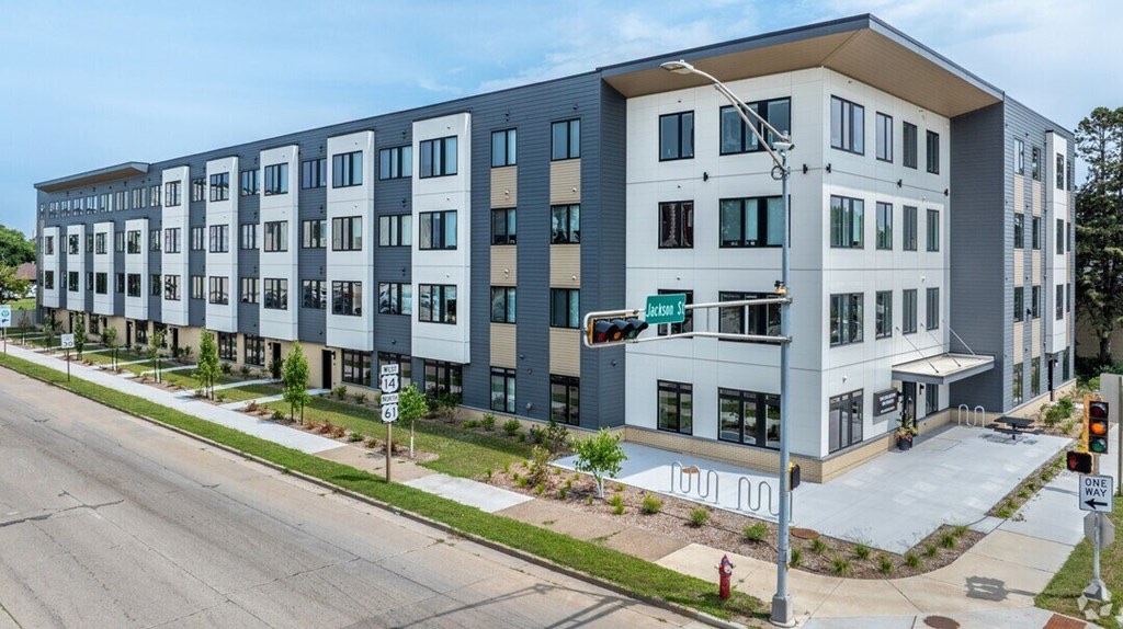 Collective on Fourth, a four-story building at the corner of Jackson Street in La Crosse, with new street trees and bike racks