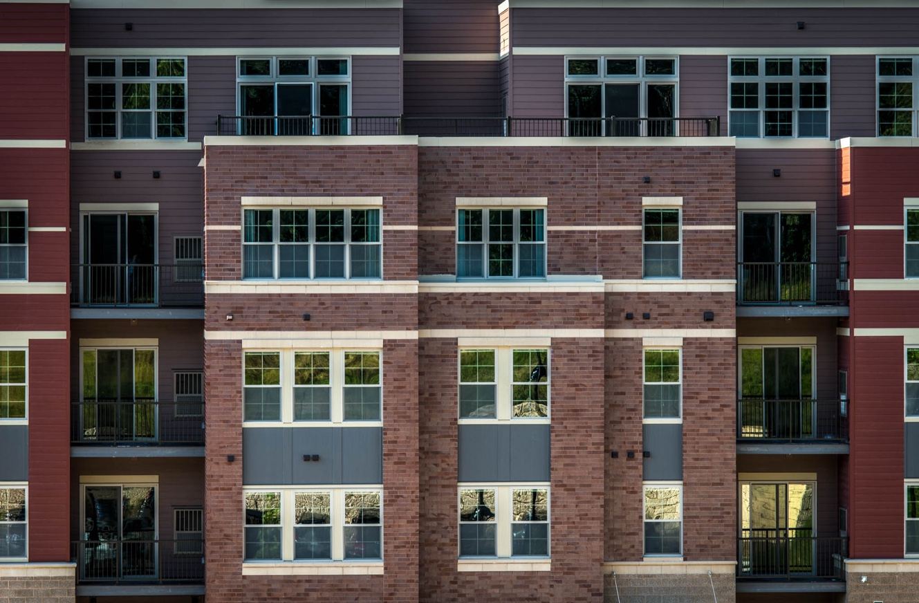 Facade of Middleton Station: brick and lap-siding bays with tall windows and private balconies